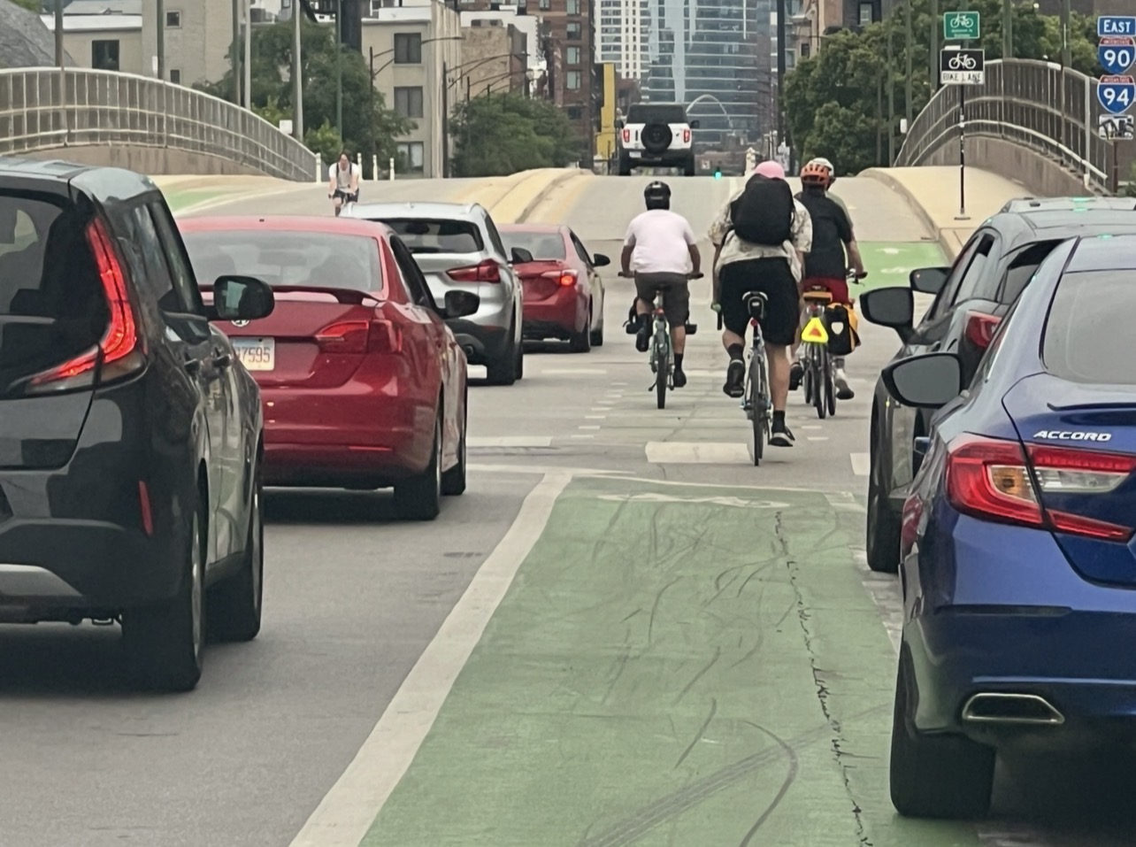 Chicago riders moving through traffic in a marked bike lane