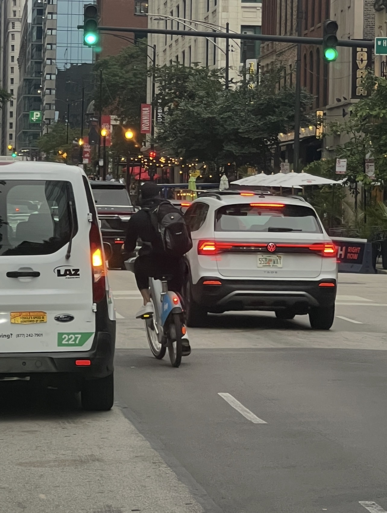 A Chicago shared-bike rider traveling near vehicle traffic